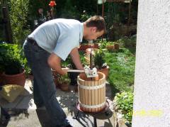 Working with the wine press, making sure all juice gets out of the fruit